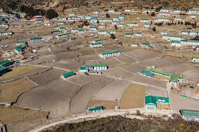 Spread out agricultural village with fields and farmers houses in a high valley