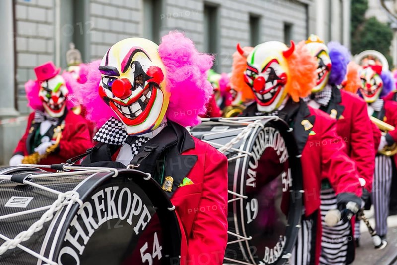 Members of the Gugge marching brass bands wearing fancy dresses and masks at the great procession of the Carnival of Basel