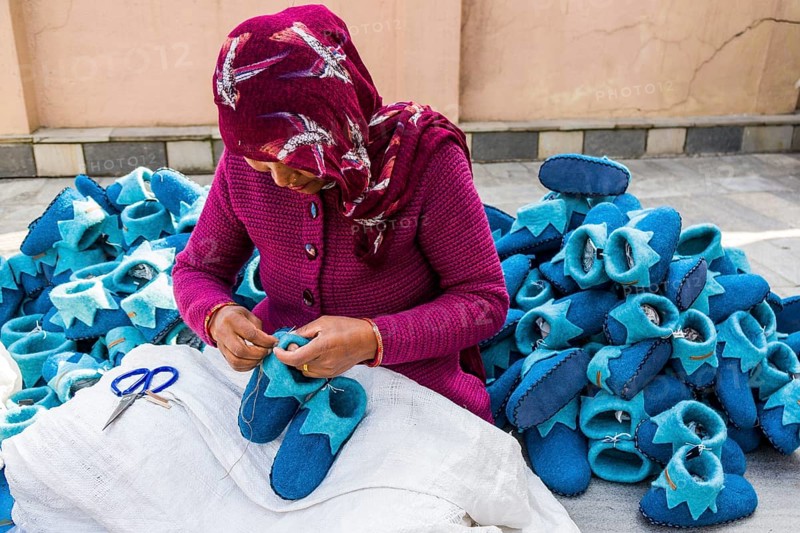Woman working on felt shoes