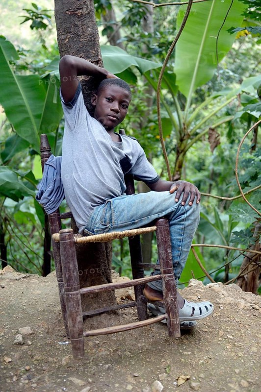 Teenager boy on a rickety chair