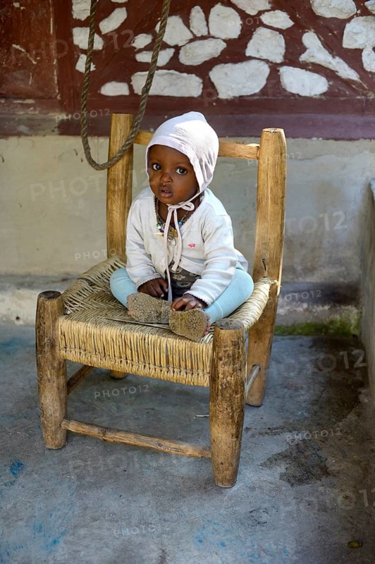 Toddler sitting on a chair