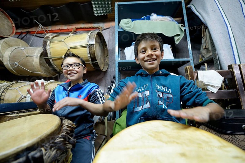 Boys drumming happily