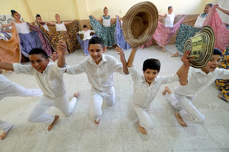 Boys taking bow with straw hats