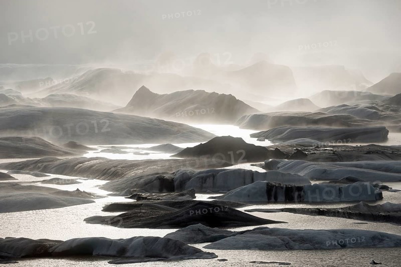 Glacial lake and glacier in fog