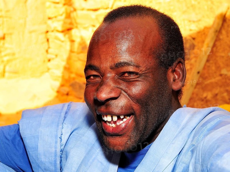 Portrait of a laughing man wearing a blue boubou