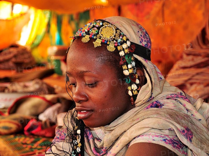 Woman with headdress in a tent