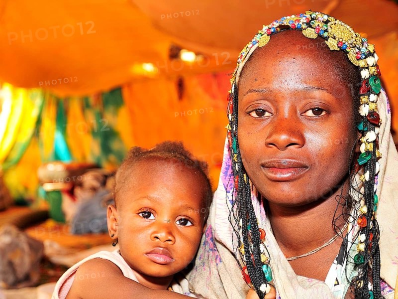 Woman with headdress with her child