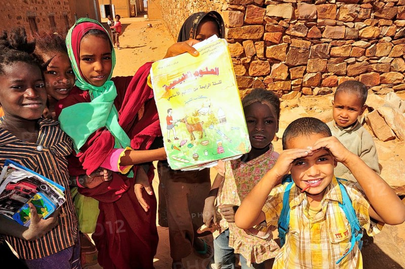 Children showing a textbook