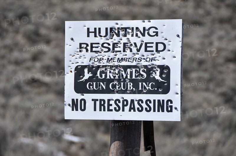 Sign with bullet holes