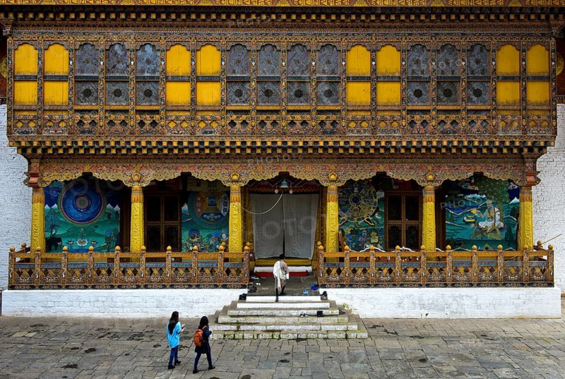 Tourists at the entrance to the coronation temple in the monastery fortress Punakha Dzong