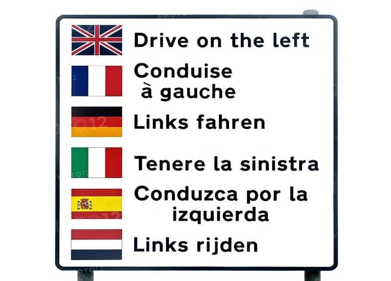 Multilingual warning sign for tourists lettering Drive on the left