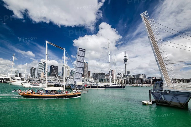 Yacht reaching the Auckland Harbor crossing an open drawbridge