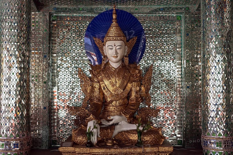 Buddha statue inside a shrine with mirror mosaic