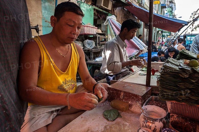 Man preparing betel nut for sale