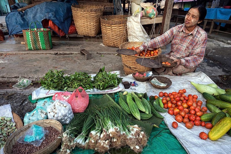 Local woman selling vegetables at the market in Nyaungshwe