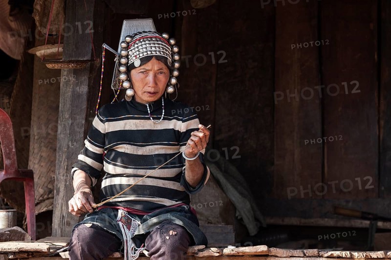 Native woman from the Akha tribe in typical clothes and typical headgear