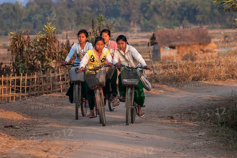 Local girls on bicycles returning from school