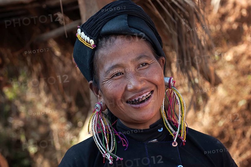 Native woman in typical clothing and headgear from the Ann tribe in a mountain village at Pin Tauk