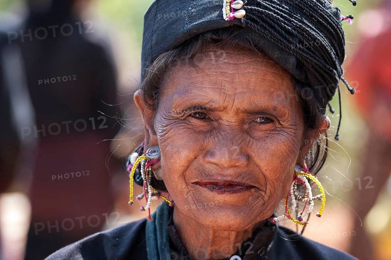 Native woman in typical clothing and headgear from the Ann tribe in a mountain village at Pin Tauk
