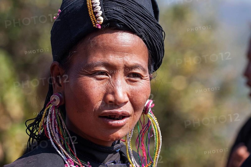 Native woman in typical clothing and headgear from the Ann tribe in a mountain village at Pin Tauk