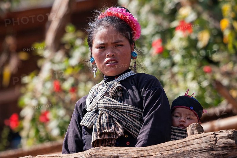 Native young woman with young child in typical clothing