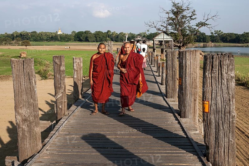 Two Buddhist monks walking on the U Bein Bridge