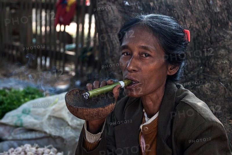 Native woman smoking a Cheeroot cigar