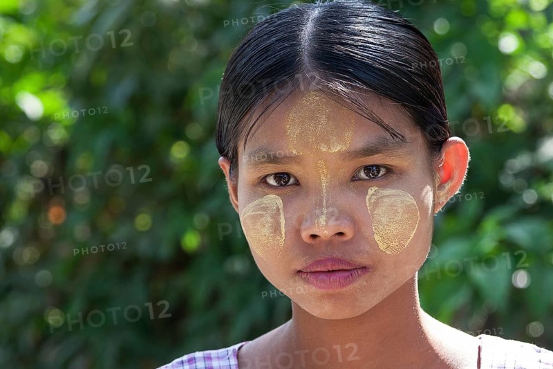Young woman with Thanaka paste on her face