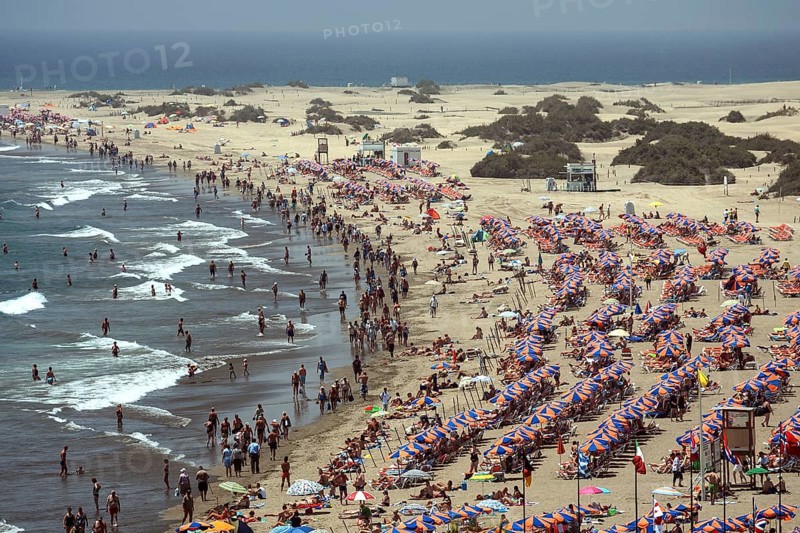 Crowded beach with umbrellas