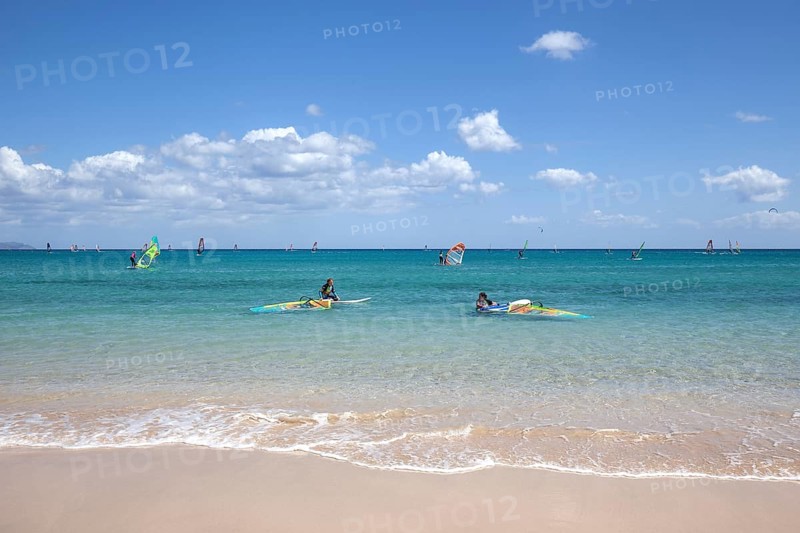 Windsurfers in the turquoise waters off the Playa Risco del Paso beach