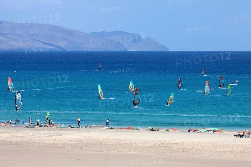 Windsurfers in the turquoise waters off the Playa Risco del Paso beach