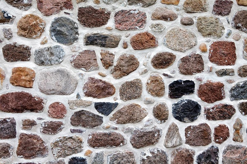 Old stone wall made of rocks and bricks