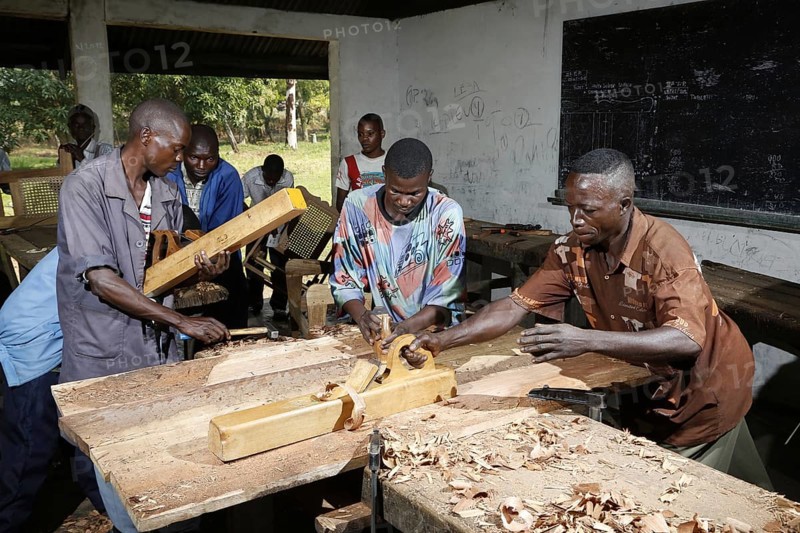 Apprentices planing wood