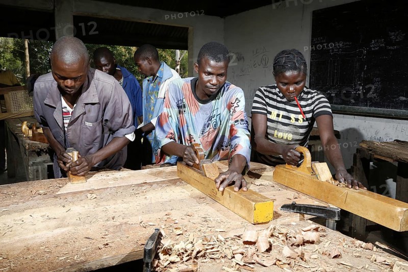 Apprentices planing wood