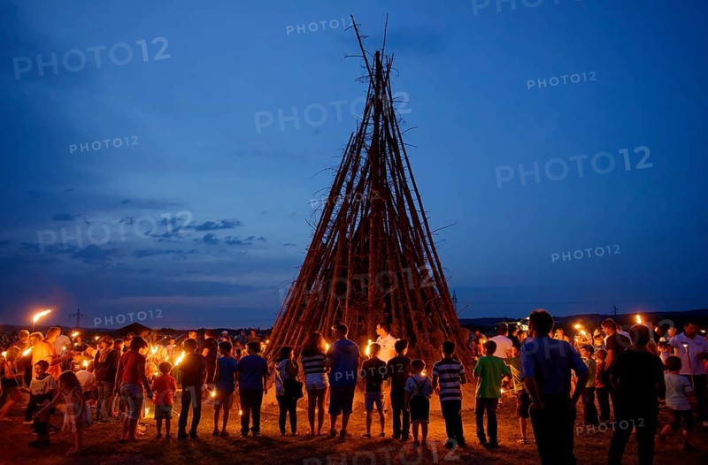 People standing around a Sonnwendfeuer bonfire