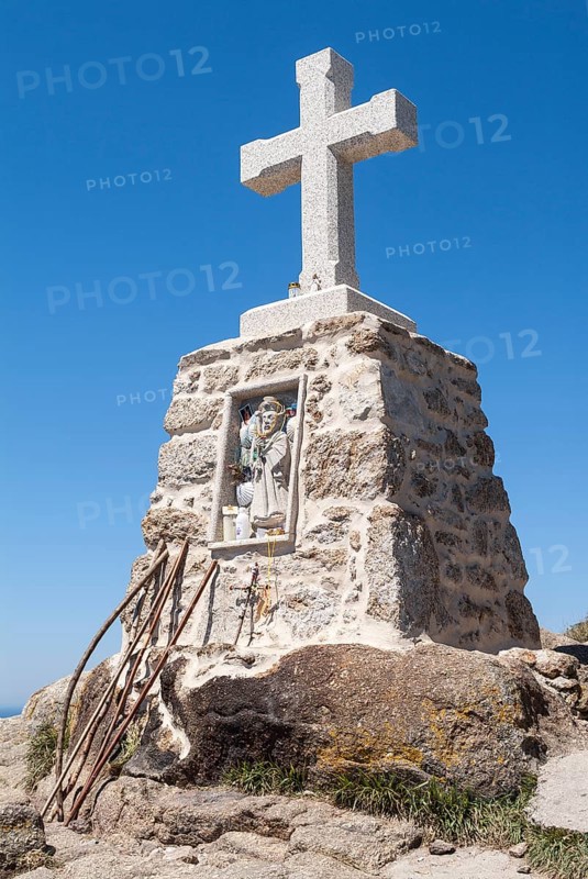 Stone cross and pilgrim sticks