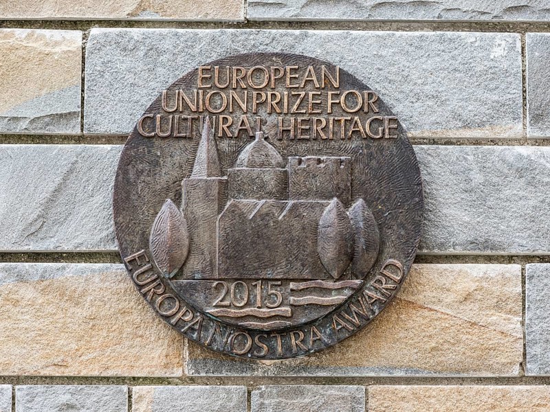 Bronze medallion on stone wall