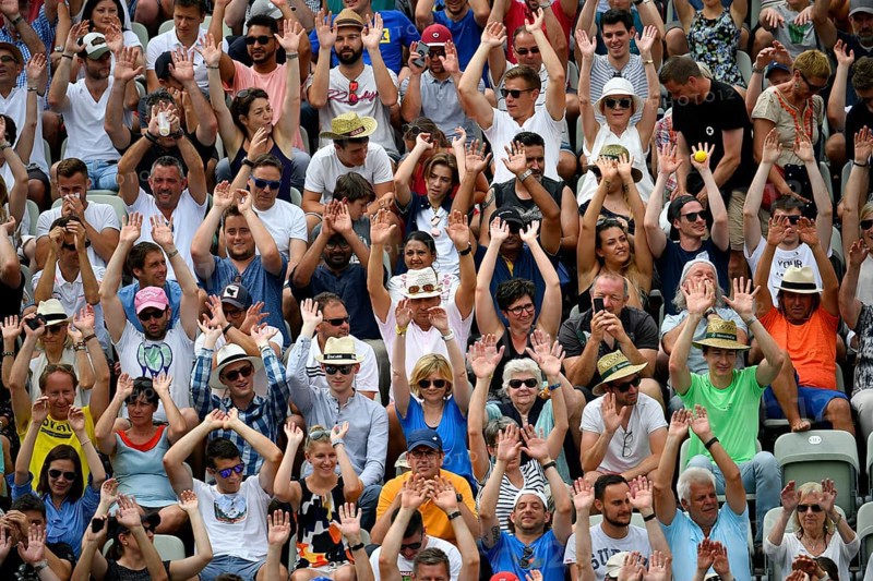 Spectators on the tribune make wave