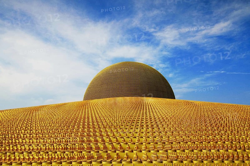 Buddhist temple Wat Phra Dhammakaya with golden Dhammakaya Buddha statues on the Chedi