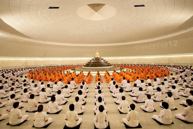Monks meditating in the Phramonkolthepmuni meditation hall