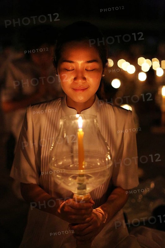 Young woman holding candle