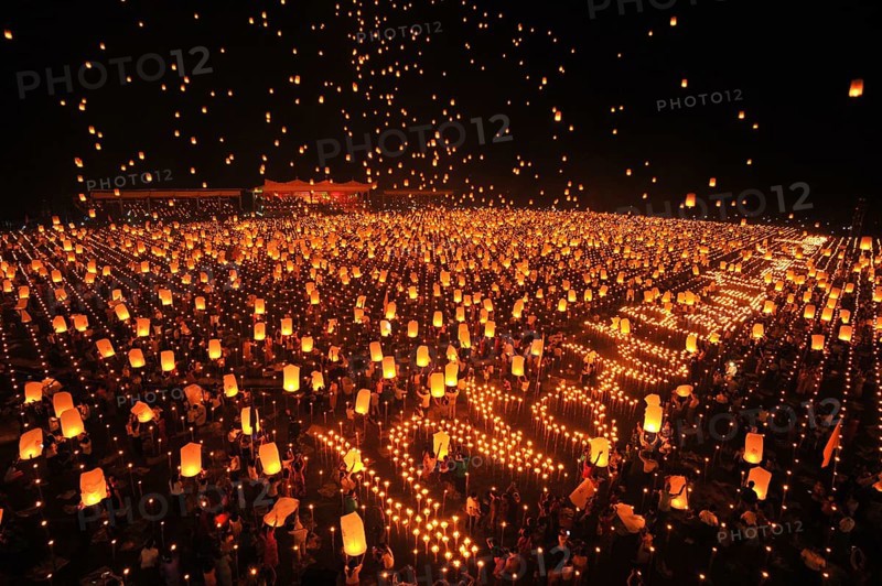 People letting sky lanterns rise