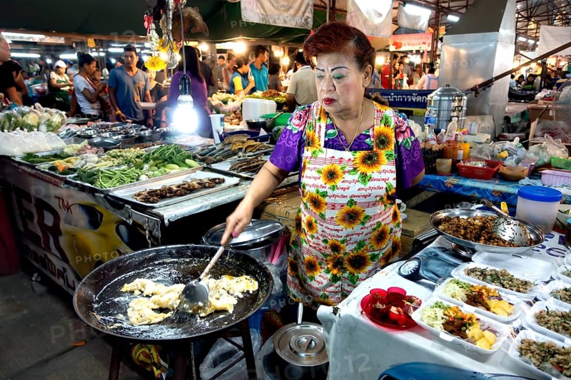 Woman preparing food in a large pan