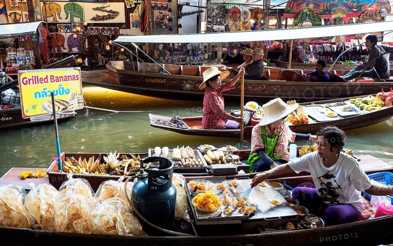 Floating Market with boats and sellers on a canal or Khlong