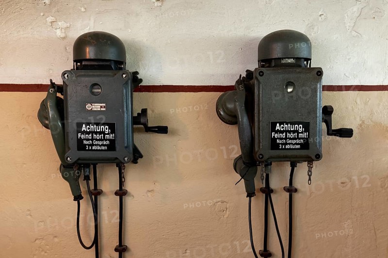 Two telephones in a bunker from the 2nd World War with inscription