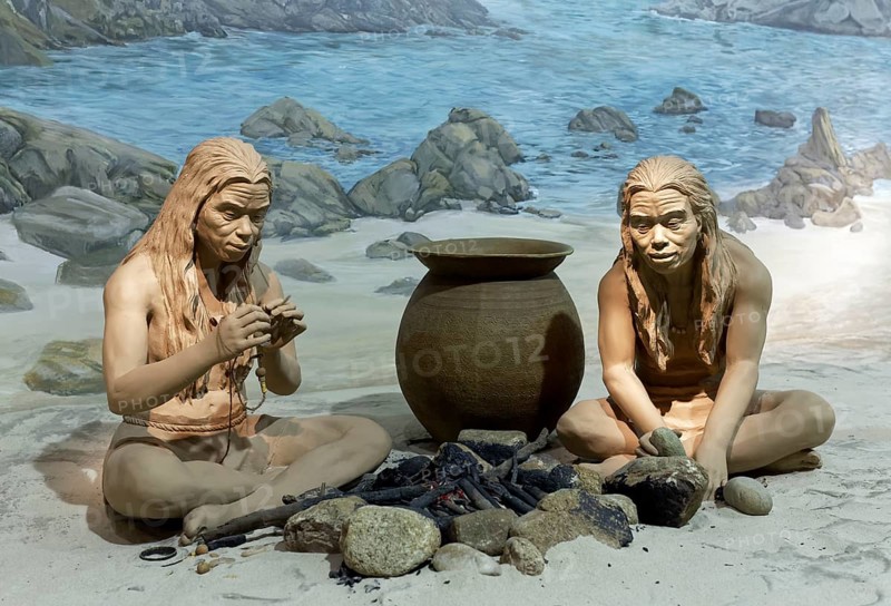 Indigenous people at a fire place on the coast