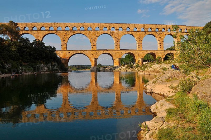 Roman aqueduct Pont du Gard reflected in the Gardon river