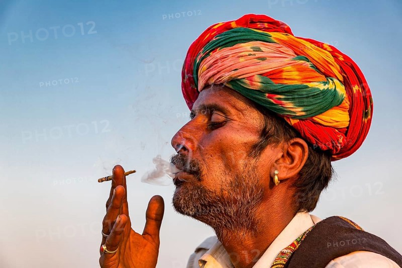 Portrait of Rajasthani man with turban smoking a cigarette