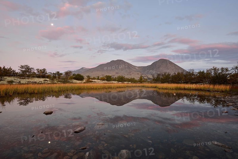 The peaks of the Stygghoin or Stygghoin mountain group reflected in a small lake