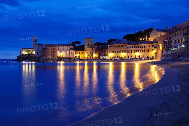 Town beach in the bay Baia del Silenzio with Chiesa di San Nicolo church